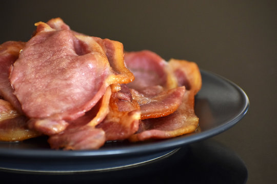 Back Bacon On A Blue Plate. Selective Focus.