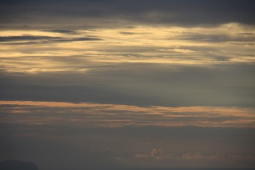 Fototapeta na wymiar sunrise with sun rays between the clouds
