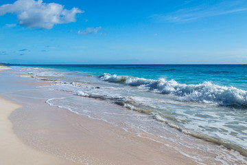 Fototapeta na wymiar Waves lapping the sand, at Elbow Beach on the island of Bermuda