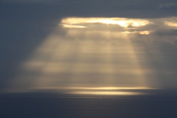 sunrise with sun rays between the clouds