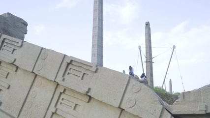 Tracking right from the side of the fallen Great Stele Number 1 to reveal all remaining standing steles at the Northern Stelae Field in Aksum, Ethiopia