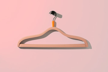 a simple empty clothes hanger on the wall hook, fashion cloth textile storage