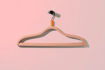 Fotobehang a simple empty clothes hanger on the wall hook, fashion cloth textile storage © Mihail