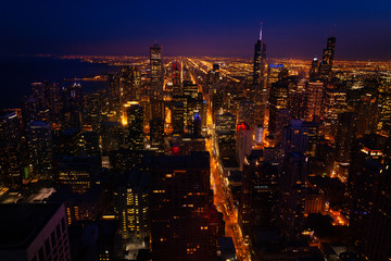 Magnificent night panorama view of streets and tall skyscrapers of Chicago from above