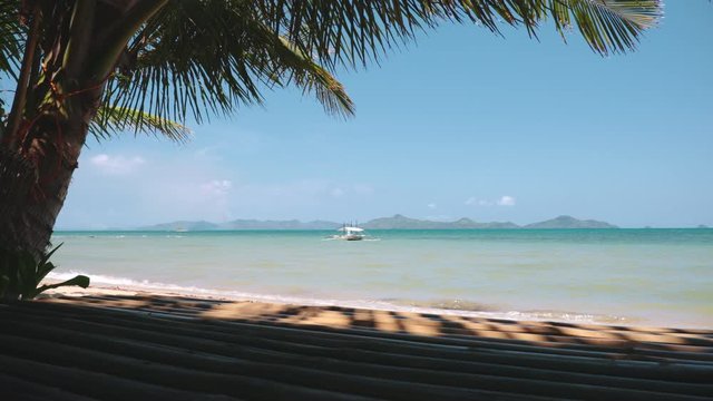 Philippines Tropical Beach View Coconut Palm Tree. Peaceful Coastline with White Sand and Turquoise Ocean. El Nido Island, Philippines Perfect Place for Getaway Vacation. Footage Shot in 4K