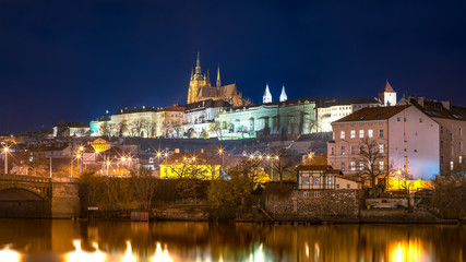 Fototapeta na wymiar Night View Across the River on Illuminated Prague Castle, Tourist Destination in Capital City of Czech Republic