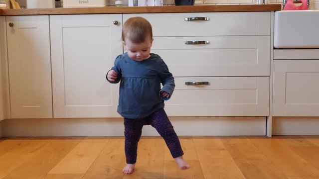4K: Baby girl / Toddler taking first steps Walking in the home - Kitchen