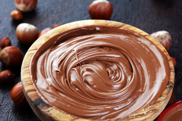 Homemade hazelnut spread in wooden bowl. Hazelnut Nougat cream with hazelnuts