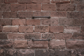 Red brick wall with a metal ladder