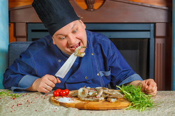 chef cooks tiger shrimps. Portrait. Funny photo. Сhef tastes tiger shrimp