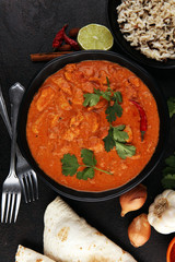 Chicken tikka masala spicy curry meat food in pot with rice and naan bread. indian food