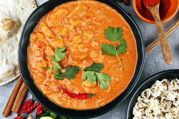Chicken tikka masala spicy curry meat food in pot with rice and naan bread. indian food