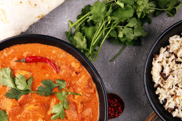 Chicken tikka masala spicy curry meat food in pot with rice and naan bread. indian food