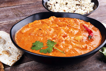 Chicken tikka masala spicy curry meat food in pot with rice and naan bread. indian food