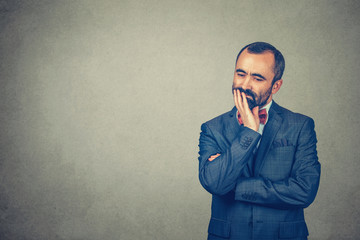 man hand on chin, thinking deeply about something, looking down