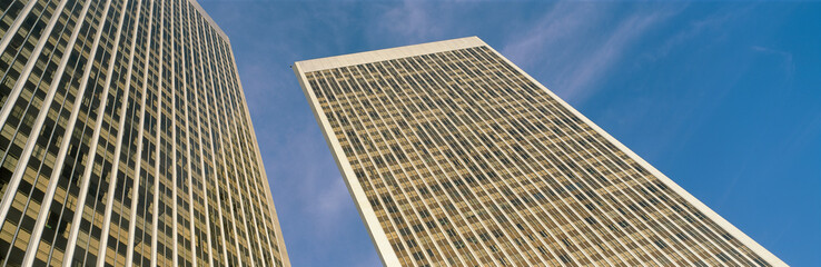 This is the view looking up at the Century City Towers. It is surrounded by blue sky during the day. © spiritofamerica