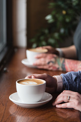 Hands holding coffee cup - 316636144