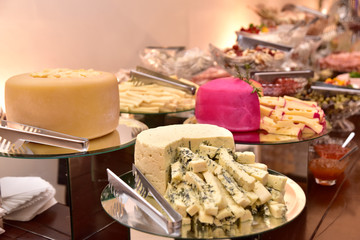 party table with gouda parmesan chees meadow freshness cut into strips with side view with blur in the photo