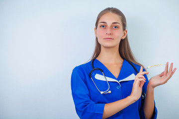 Smile young female doctor or nurse holding thermometer on white background, closeup. Medical...