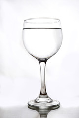 translucent glass bowl with liquid inside isolated on white background