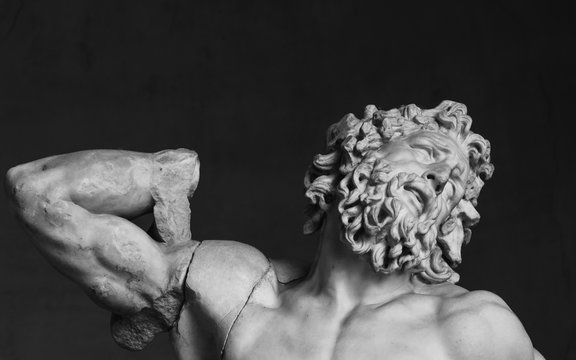 Black And White Closeup Photo Of Classical Roman Statue Of Man With A Suffering Face