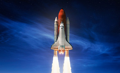 Space shuttle on dark sky with clouds background. Gradient. Rocket take off from planet Earth. Space art wallpaper. Elements of this image furnished by NASA	
