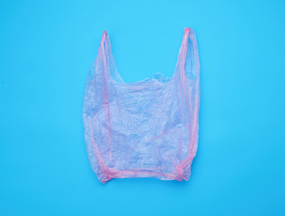 open empty plastic pink bag for products on a blue background
