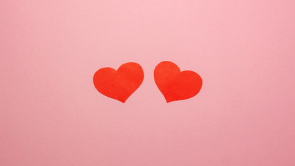 Fototapeta na wymiar Two red hearts on pink background. Valentines day concept. Flat lay top view