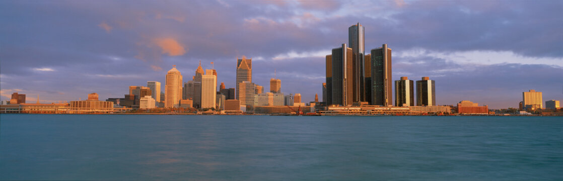 This is the skyline and Renaissance Center at sunrise. It is a view of what they call the Motor City from Windsor, Canada. It shows the Detroit River in the foreground.