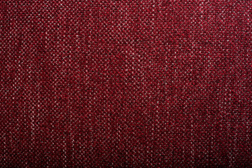 Close up shot of colored sofa fabric texture. Red color texture.  