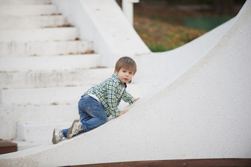 The boy is sitting on a white border. Blurred image - 316641508