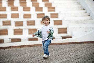 Happy boy runs around the stage. Blurred image - 316641583
