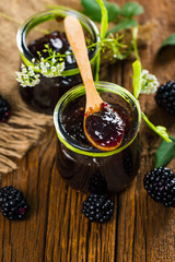 Blackberry Jam Preserves on Old Wooden Background. Selective focus.