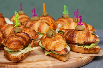 Mini croissants with fish. Fast food.