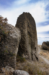 Large mountain cliffs and stones. Mountain trail among them. Travel and adventure.