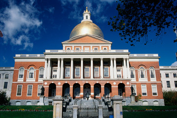 This is the State Capitol building, also known as the State House. It has a gold dome with columns...