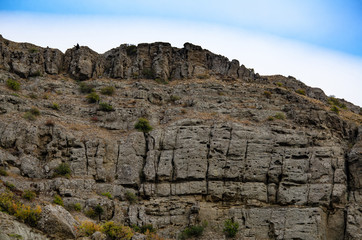 Mountain landscape. Sheer cliff and sky. Travel and adventure.
