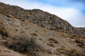 Mountain landscape. Sheer cliff and sky. Travel and adventure.