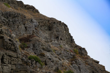 Mountain landscape. Sheer cliff and sky. Travel and adventure.
