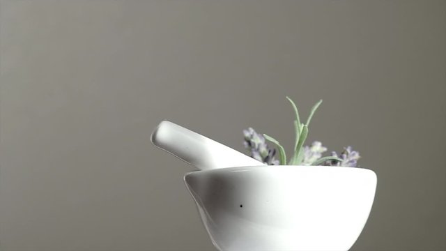 pestle and mortar spin  for beauty spa and wellness background. close up 4k video slow-motion . herbal aromatherapy medicine with lavender for stress relief and relax sleep.