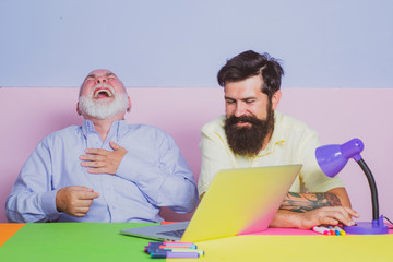 Funny photo of businessman wearing shirt working with laptop at table. Cheerful business men team...