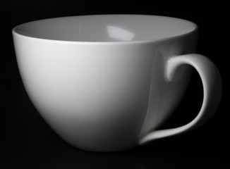 White porcelain cup on black background