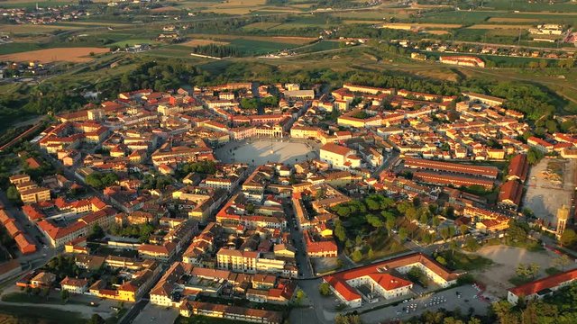 Aerial, reverse, drone shot, tilting away from the Palmanova star fortress, on a sunny evening, in Udine, Italy