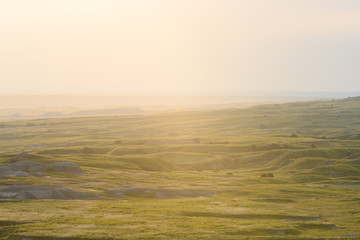 Bright Light Shines Over Badlands Fields