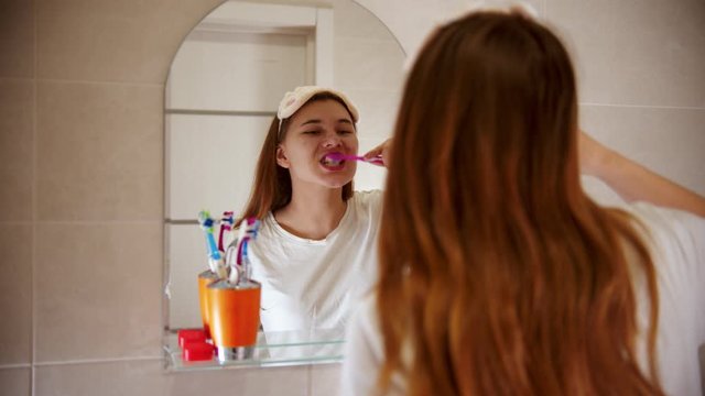A young woman brushing her teeth