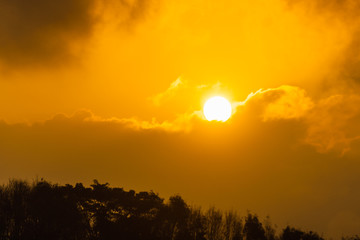The sun is floating in the sky.