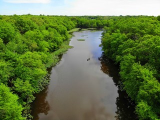 Fototapeta na wymiar The aerial view of the green trees and water along Becks Pond, Newark, Delaware, U.S.A