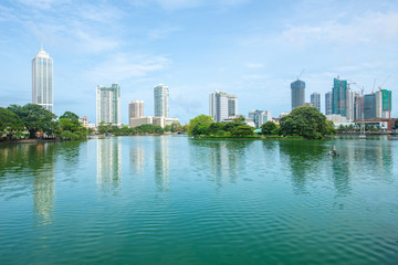 Fototapeta na wymiar View of Colombo cityscape reflection on Beira Lake a lake in the center of the city. Colombo is the commercial capital and largest city of Sri Lanka.