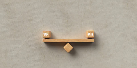 wooden blocks formed as a seesaw with the words WIN and WIN on paper background, symbolizing balance