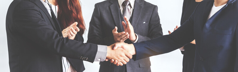 Image two business partners in elegant suit successful handshake together standing in front of...